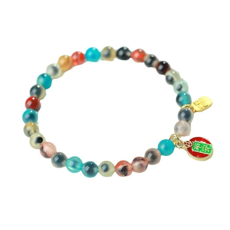 Women's geometric bracelet with colourful sugar heart agate beads and a detailed copper coin snake chain.