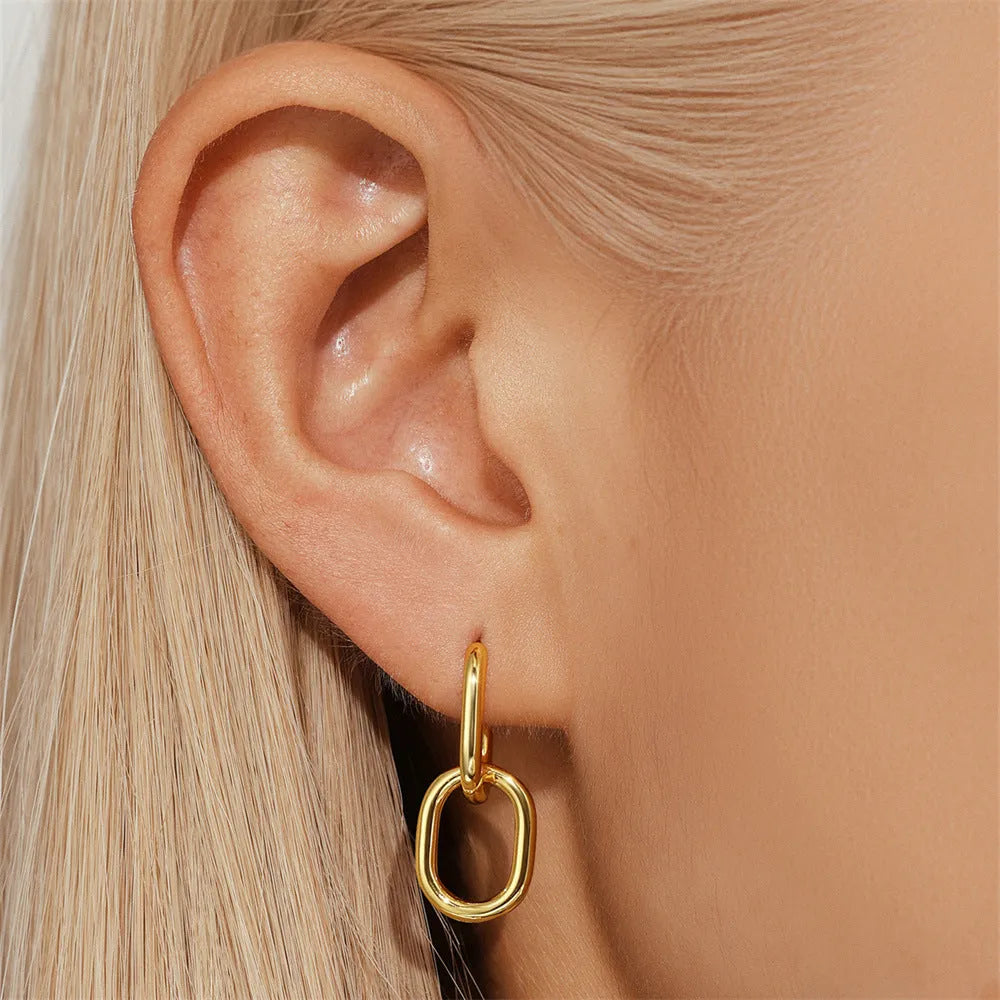 Brass geometric earclip earrings with gold electroplated finish and round design elements