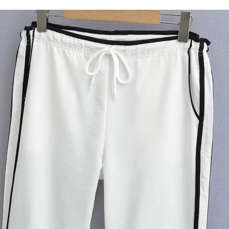 Women's loose straight-leg trousers with contrast ribbon detail in navy blue.