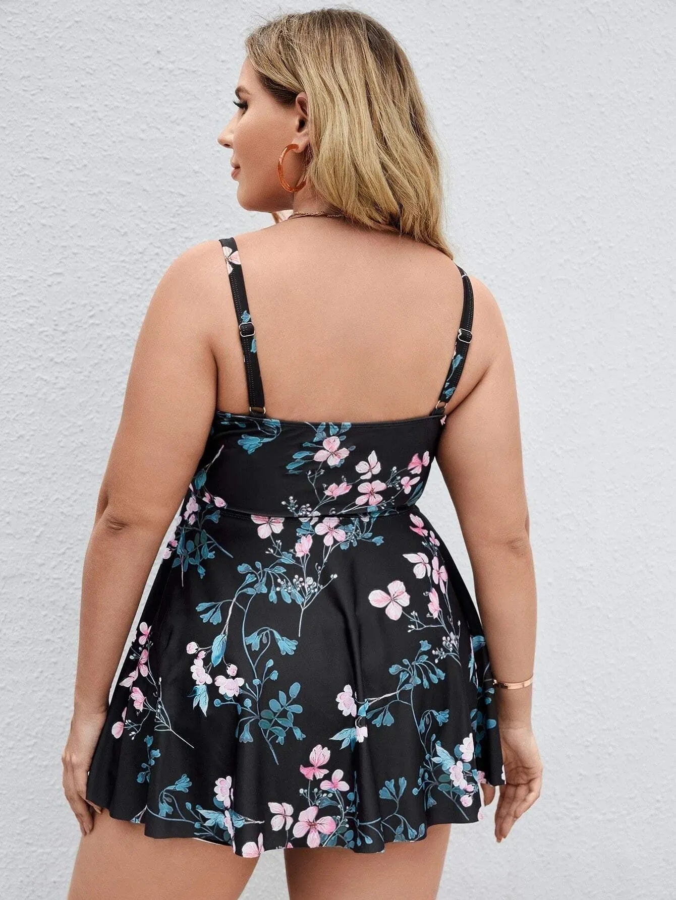 Women's floral print one-piece swimsuit on hanger, showing split colour design and high elasticity polyester fabric.
