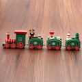 Four mini wood train cars in red, white, and green paint linked together on a shelf