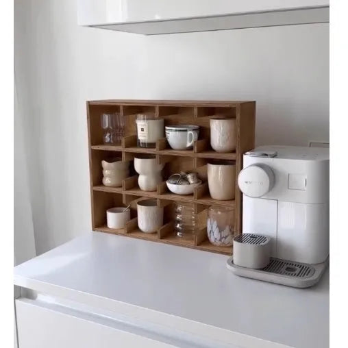 Square solid wood storage rack with multiple grid compartments for cups and mugs in a birch wood finish.