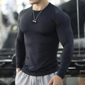 Men's black fitness tights with long sleeves and slim fit for running and gym workouts