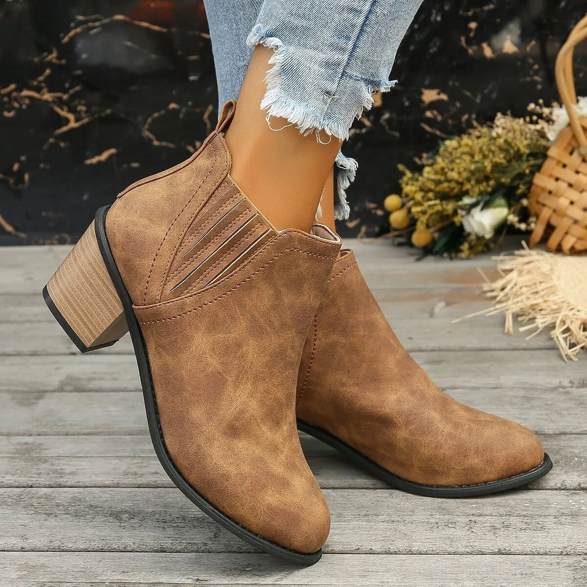 Black women's slip-on ankle boots with a pointed toe and a thick, low square heel on a rubber sole.