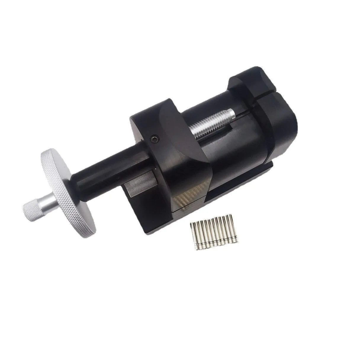 Alloy steel watch strap stripping machine tool set for watch repair on a workbench.