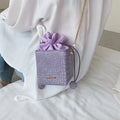 Small women's messenger bag with chain accents in six colour options including black green pink purple white yellow