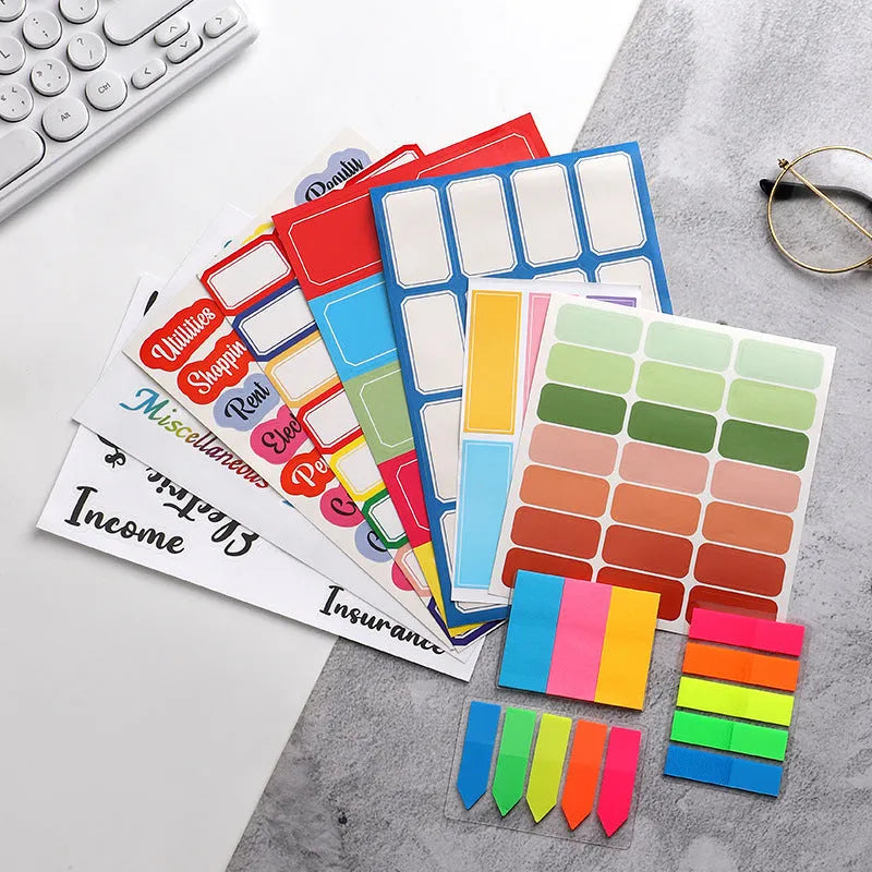 Assortment of paper adhesive stickers, labels, A6 rulers, and sticky notes in various colours and grid layouts.