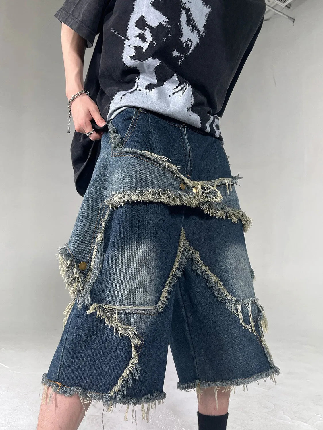 Men's blue denim shorts with frayed five-pointed star detailing and loose fit for summer casual wear