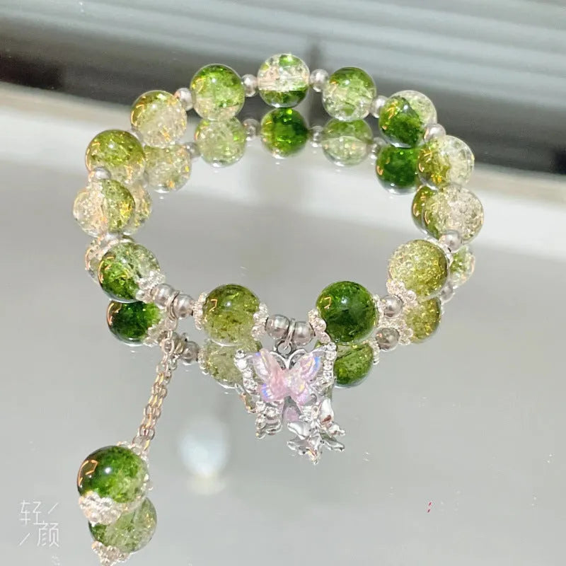 Chinese style glass bead bracelet with bamboo leaf design and manual craftsmanship details.