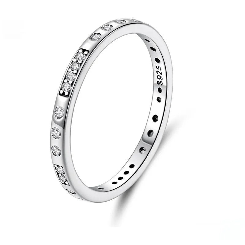 Close-up of a women's oxidised black silver alloy ring with an etched 'I love you' moss password design on a simple band.