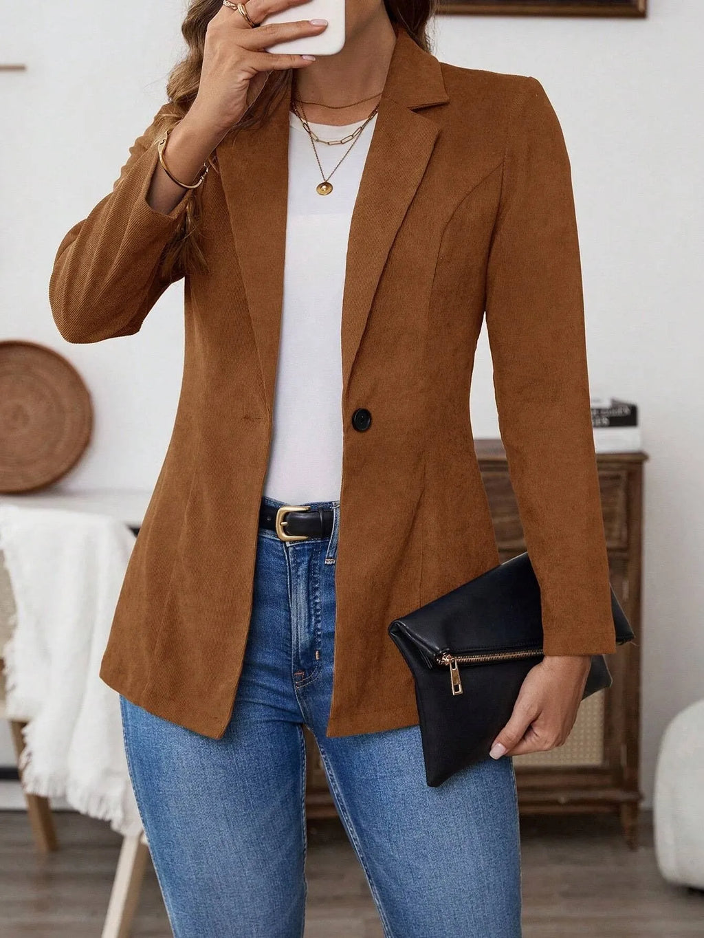 Brown single-breasted leisure suit coat with a lapel collar on a hanger.