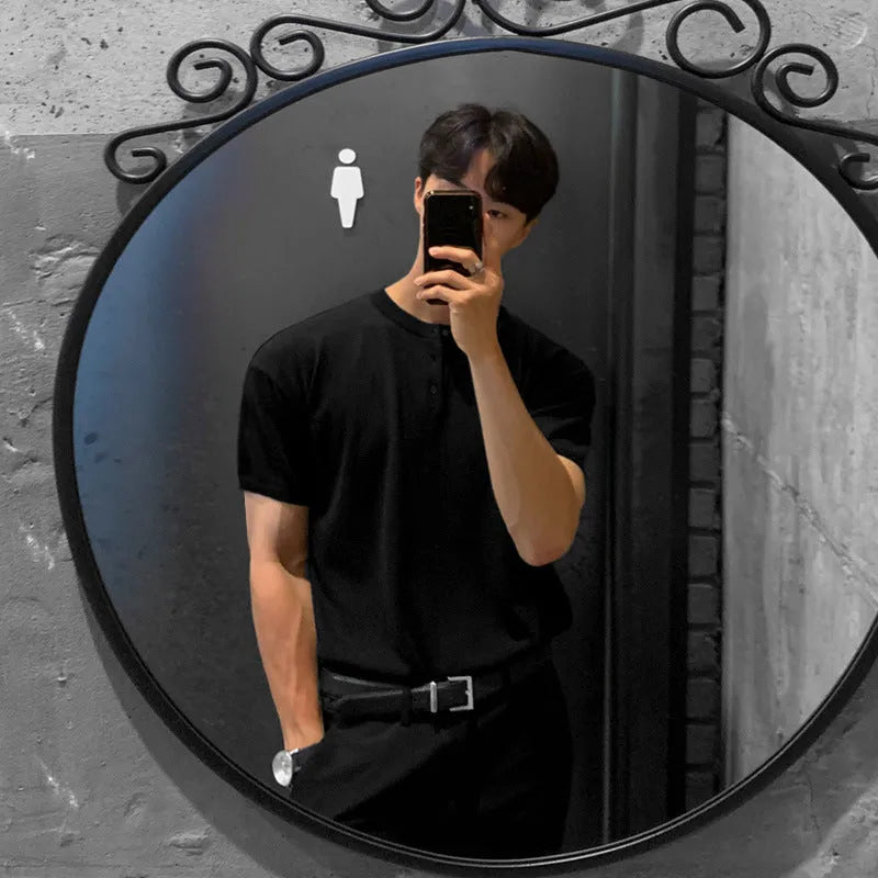 Man wearing a thin black slim-fit knitted short-sleeved pullover shirt.