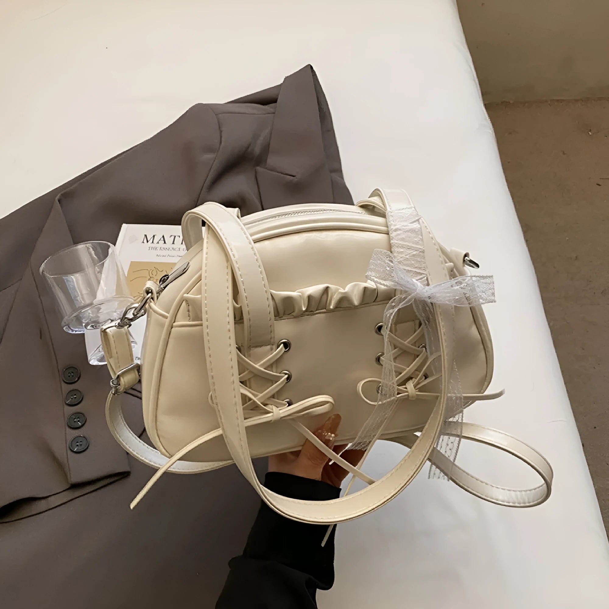 PU leather ladies shoulder handbag with phone compartment in milky white colour showing decorative stitching