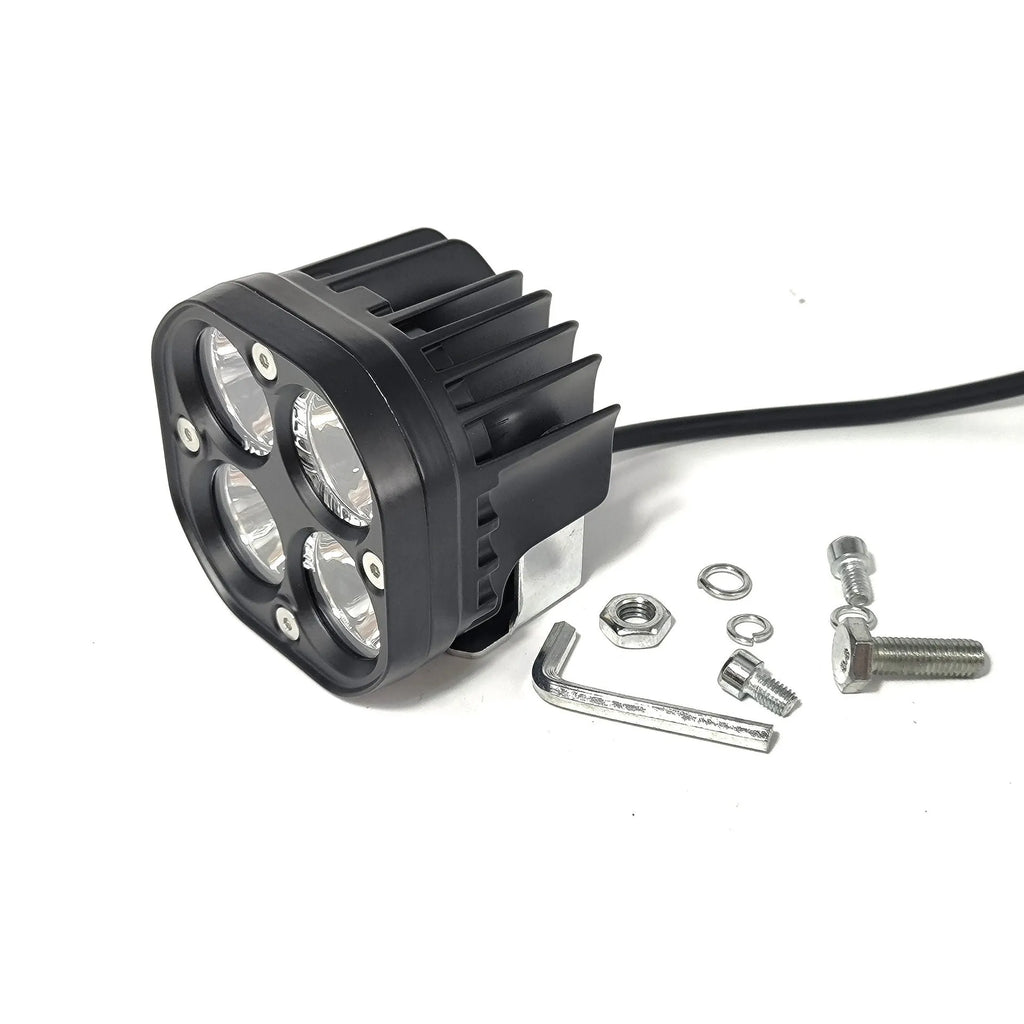 Four-eye automotive headlight with aluminium mounting base, showing four-leaf clover light pattern