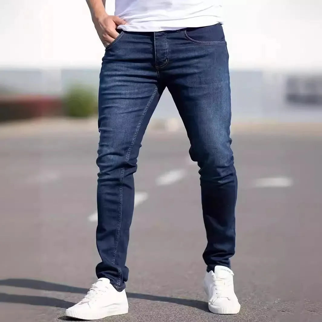 Dark blue men's slim fit casual jeans with mid waist and skinny leg style.
