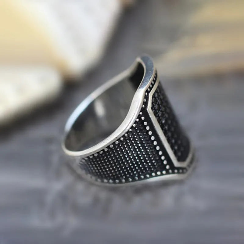 Unisex black alloy ring with copper inlay and a zircon stone.