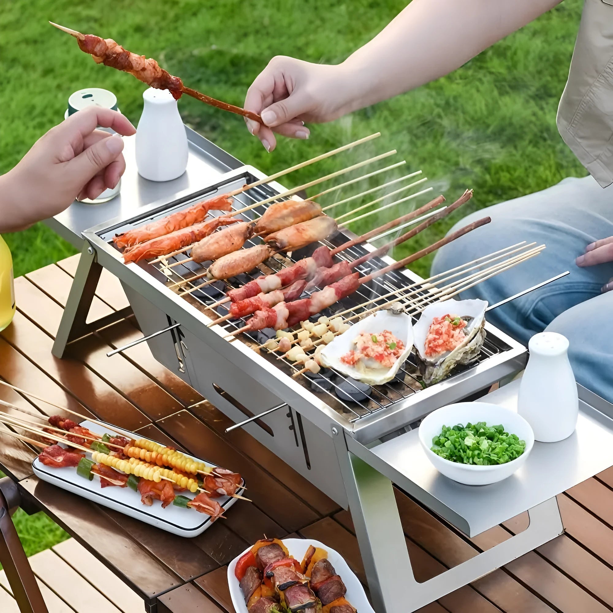 Small foldable portable charcoal barbecue grill shown open for cooking and folded flat.