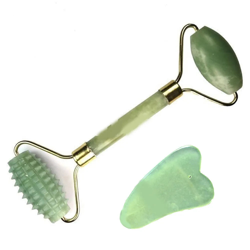 Natural green jade face massager roller and scraper set on a clean surface