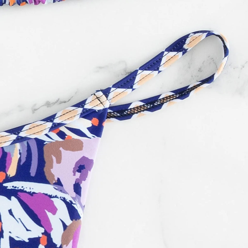 Women's floral print polyester triangle bikini swimsuit with briefs-style bottom.