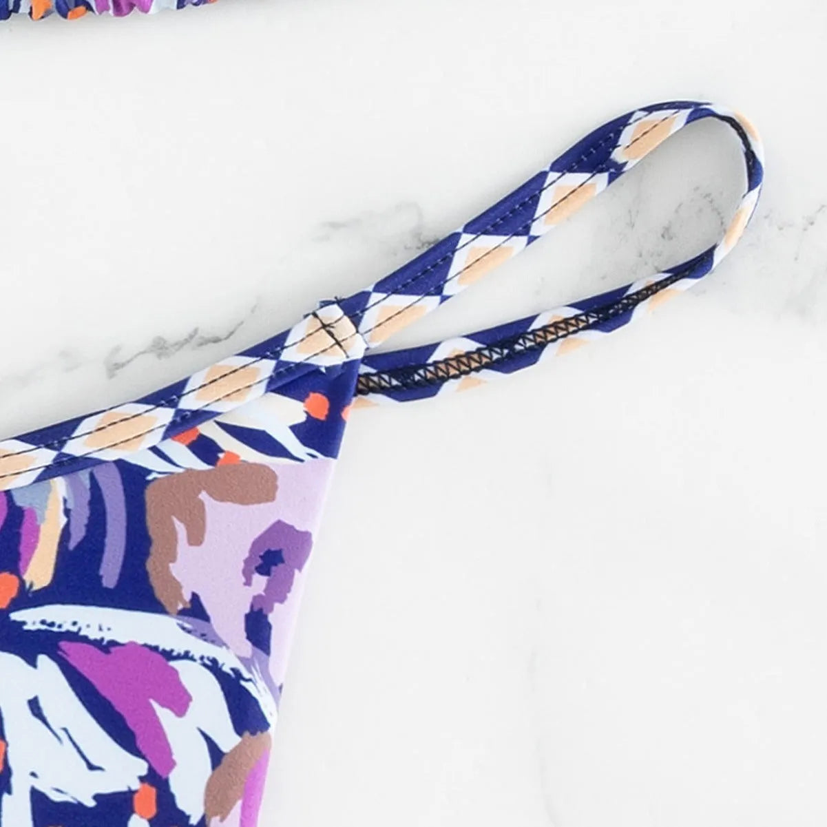 Women's floral print polyester triangle bikini swimsuit with briefs-style bottom.