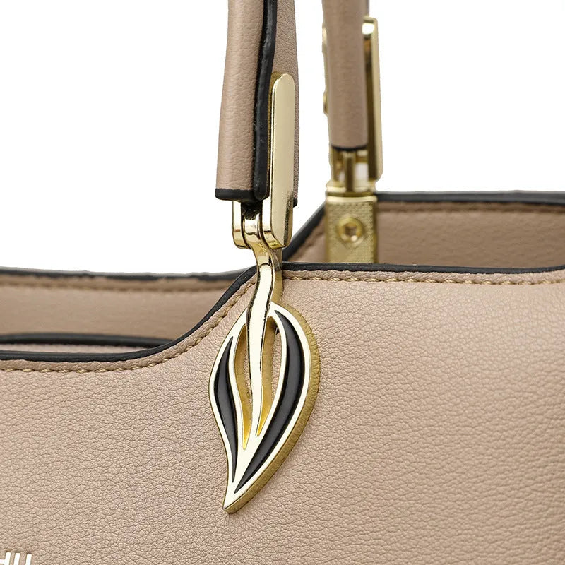 Women's black PU leather messenger bag with multi-layer interior compartments and a shoulder strap