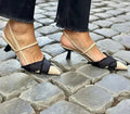 Women's apricot and black colour block stiletto heel sandals with pointed toe and ankle buckle.