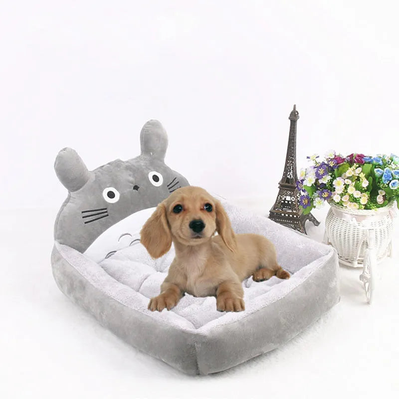 Cartoon-style plush pet sofa bed with a raised rim for a small dog or cat, shown in a blue colour