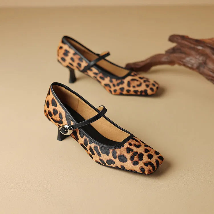 Women's black square toe stiletto ankle-strap heels with horse hair upper on a plain background.