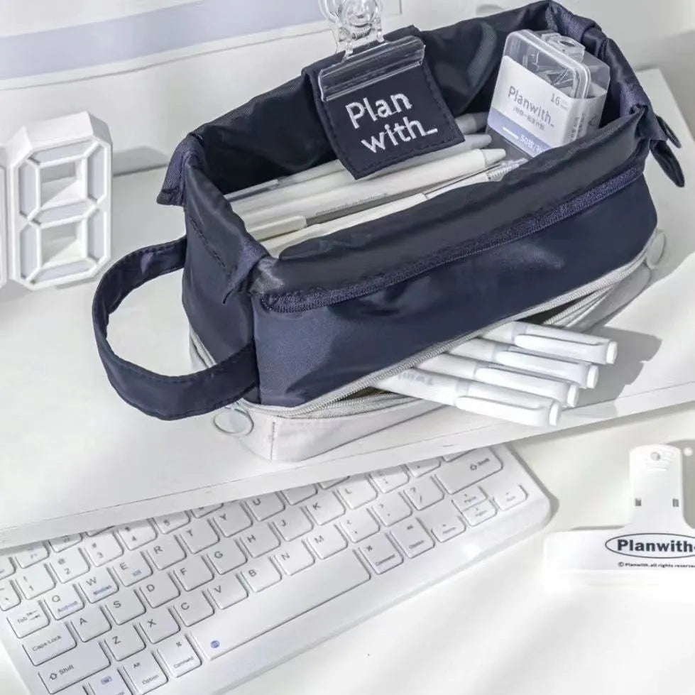 Folding double layer student pencil case in blue, navy blue, and cream white colours made from polyester fabric.