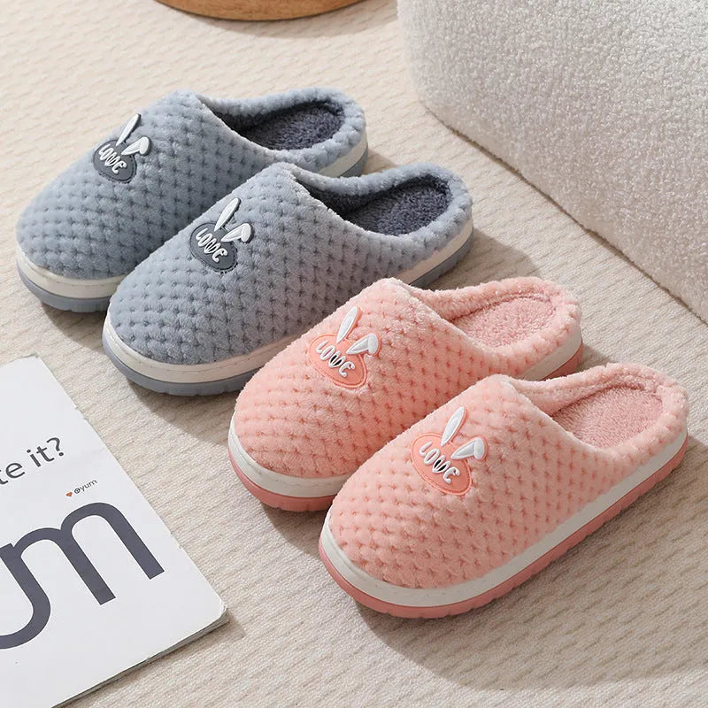 Women's rabbit and plaid print artificial fur slippers with thick rubber sole.