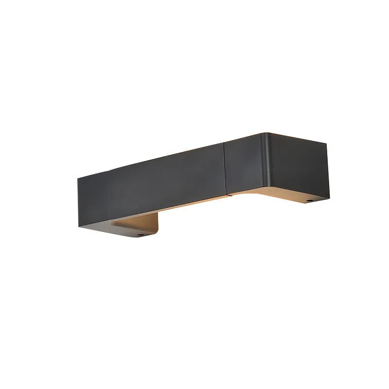 Modern minimalist wall lamp with aluminium shade in gold finish against a white wall