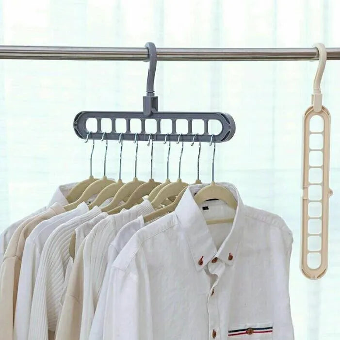 Plastic clothes hanger with rotating hook in pink and green colours on a rail.
