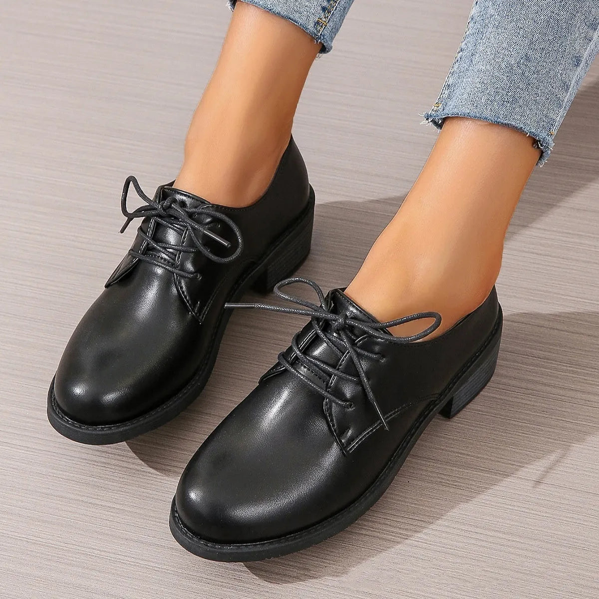 Black women's low top work shoes with a short chunky heel and pointed toe.