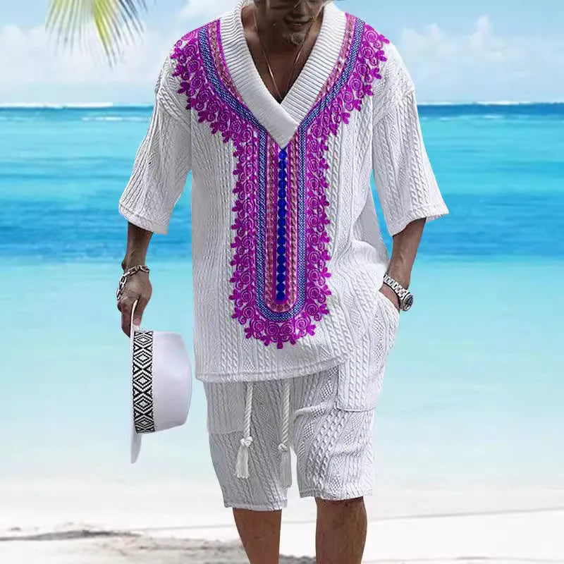 Man wearing a printed drop-shoulder knitted top and matching shorts from a two-piece lounge suit.