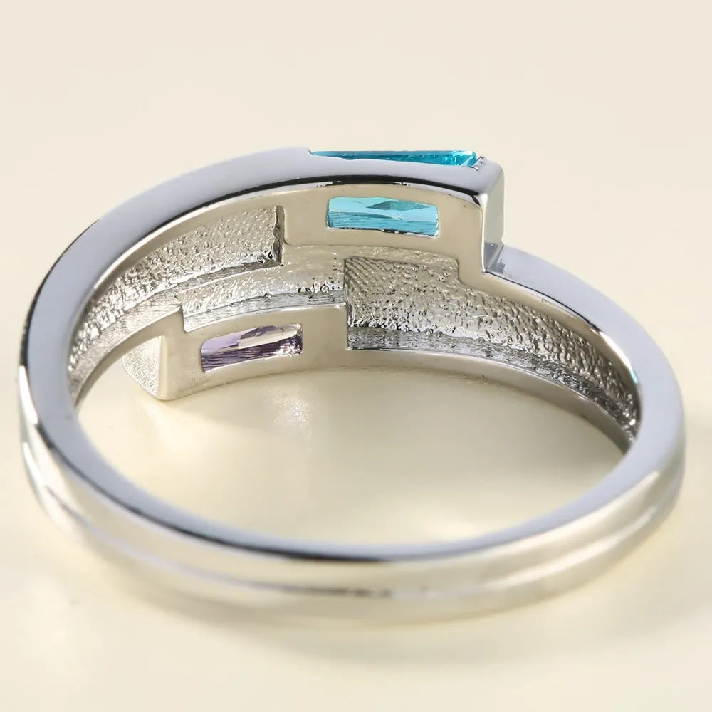 Silver-coloured copper ring with a central inlaid zircon stone, shown on a finger.