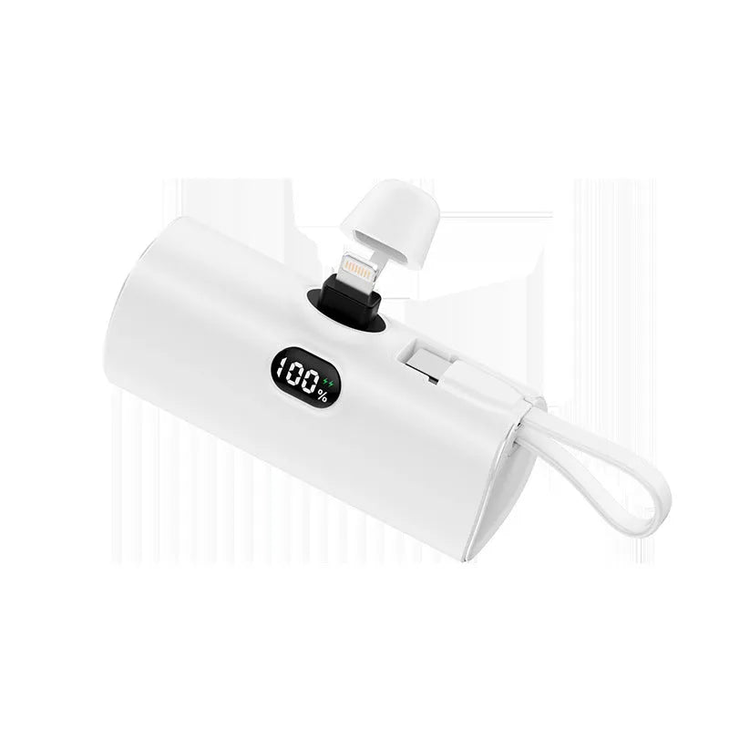 Compact wireless power bank with digital display showing battery percentage and built-in folding plug
