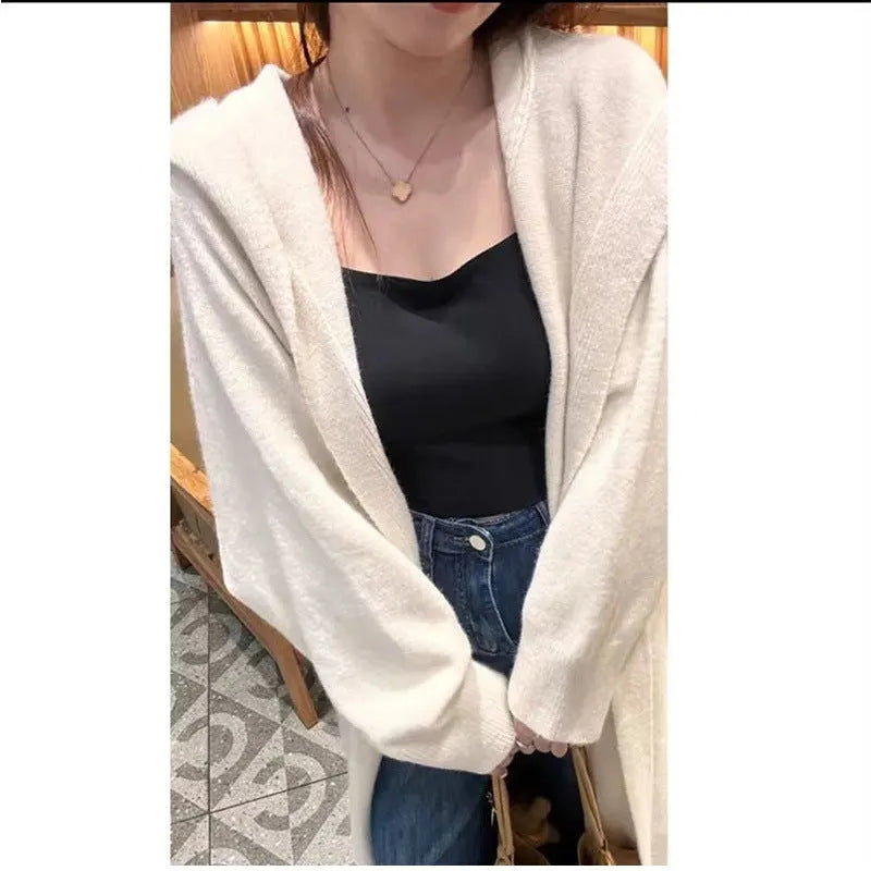 Women's long hooded knitted cardigan in loose fit, shown in oatmeal colour.