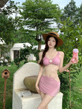 Women's black three-piece bikini swimsuit with a brief, backless style.