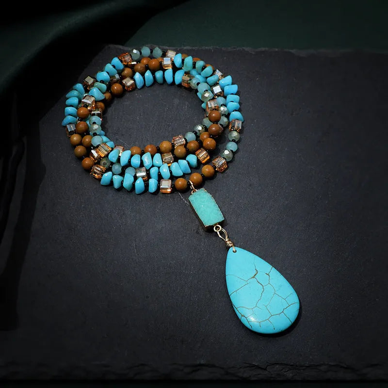 Turquoise blue water drop shaped pendant necklace with ball bead chain and geometric design elements
