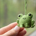 Handmade green plush frog car pendant hanging, showing woven texture and 15cm length