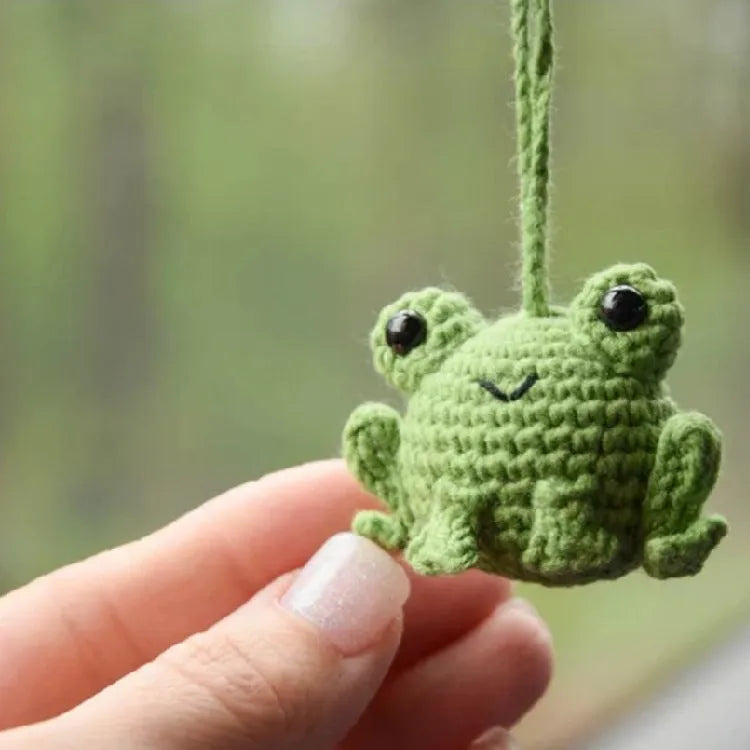 Handmade green plush frog car pendant hanging, showing woven texture and 15cm length