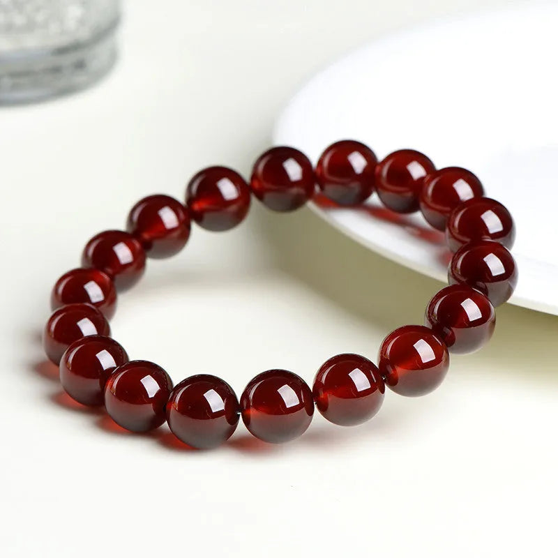 Natural orange red garnet crystal ball bracelet with ruyi charm detail in retro unisex style