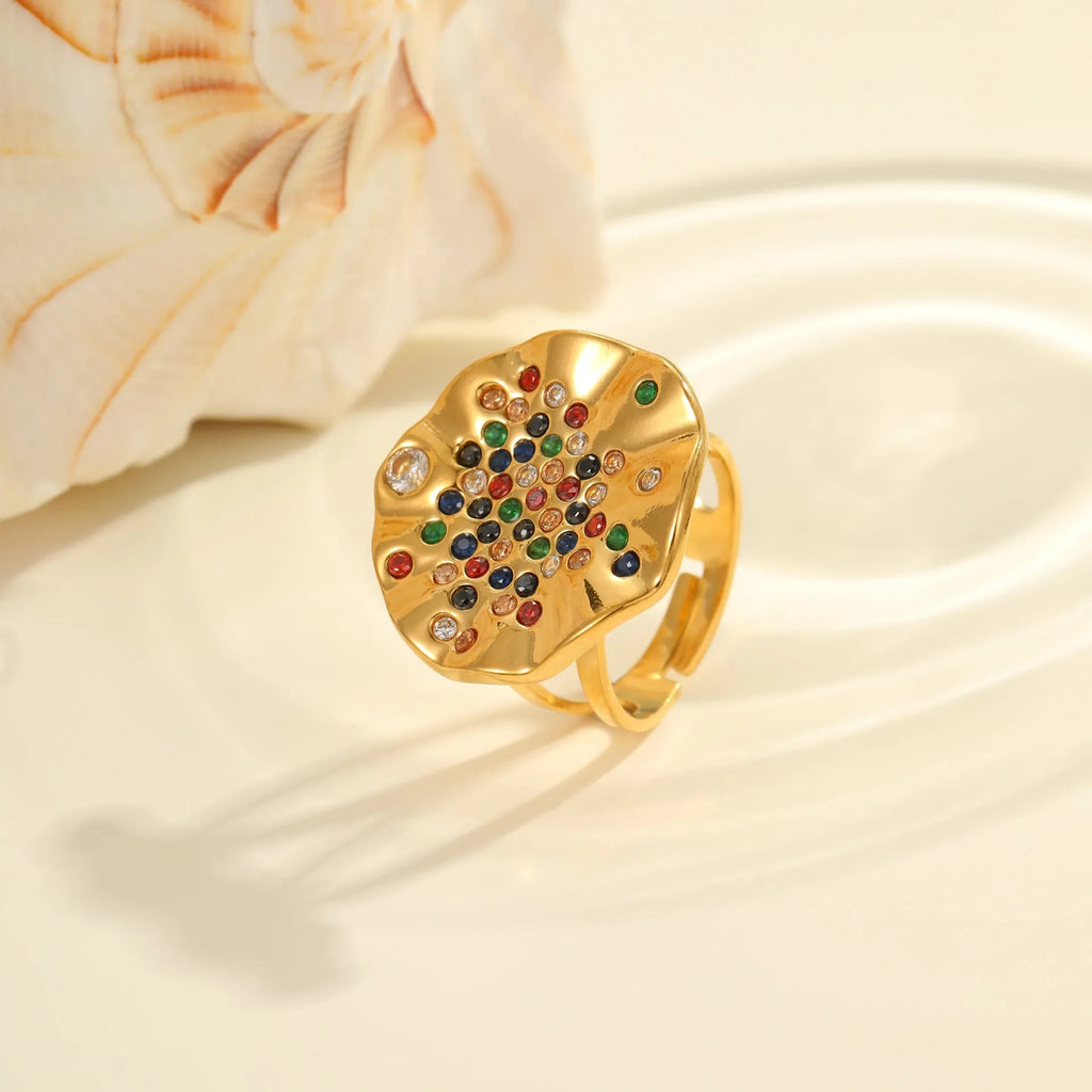 Geometric pleated inlaid colour diamond titanium steel ring on a hand, showing open mouth adjustable design.