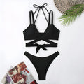 Women's solid colour strappy bikini swimsuit in black, blue, red, rose red, or white on a mannequin.