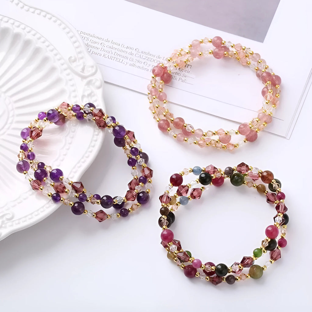 Handmade women's bracelet with tourmaline, strawberry quartz, and amethyst beads on adjustable rope