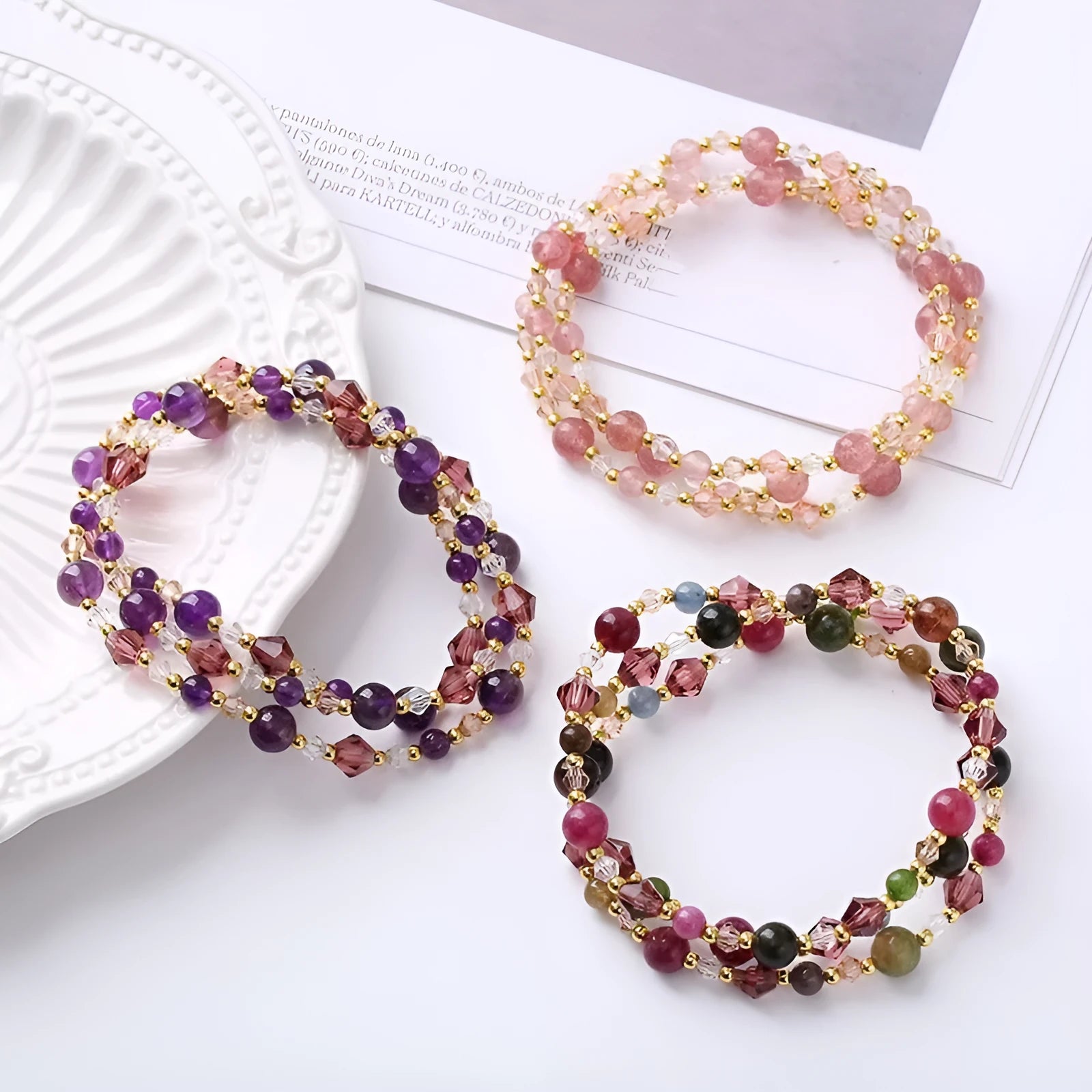 Handmade women's bracelet with tourmaline, strawberry quartz, and amethyst beads on adjustable rope