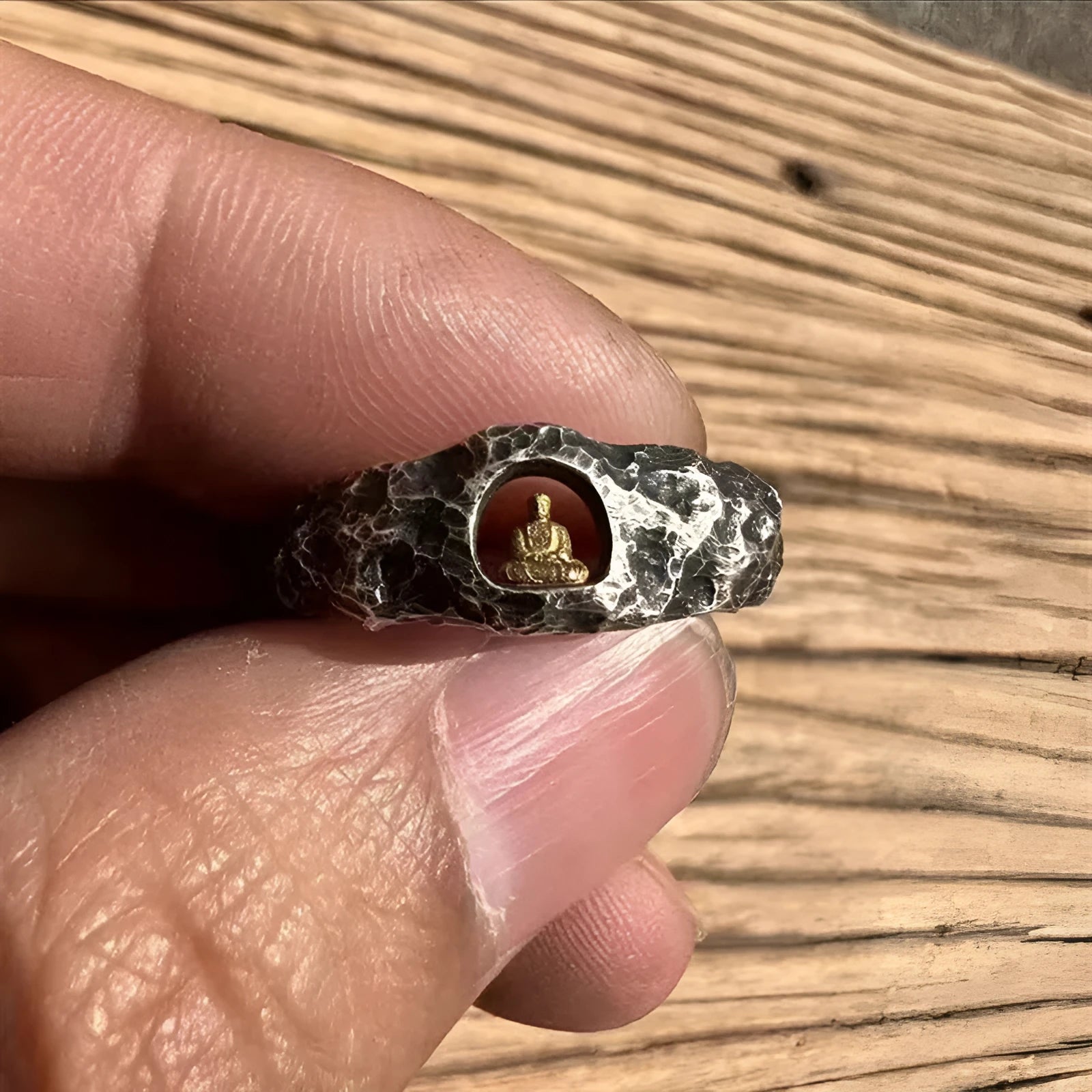 Hand-forged copper Grotto Buddha ring with rock texture on a size 8 band.