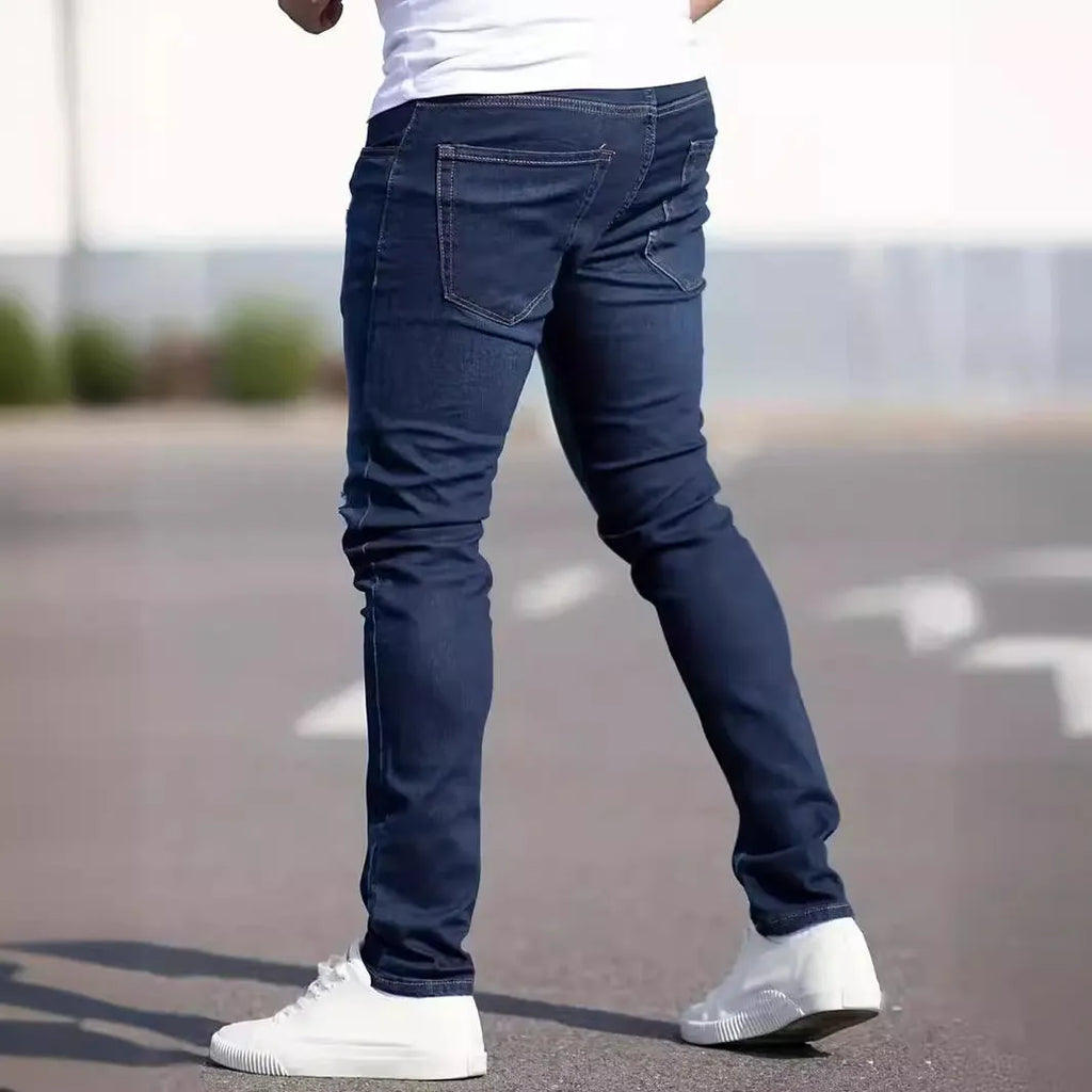 Dark blue men's slim fit casual jeans with mid waist and skinny leg style.