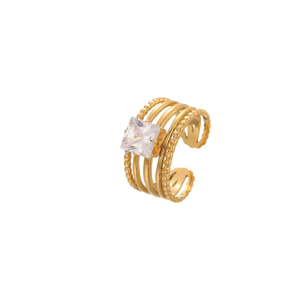 Gold-toned stainless steel ring with zircon details in a geometric heart shape design on a finger.