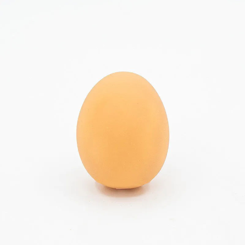 White simulation egg dog toy with textured surface for squeaking sound and tooth cleaning